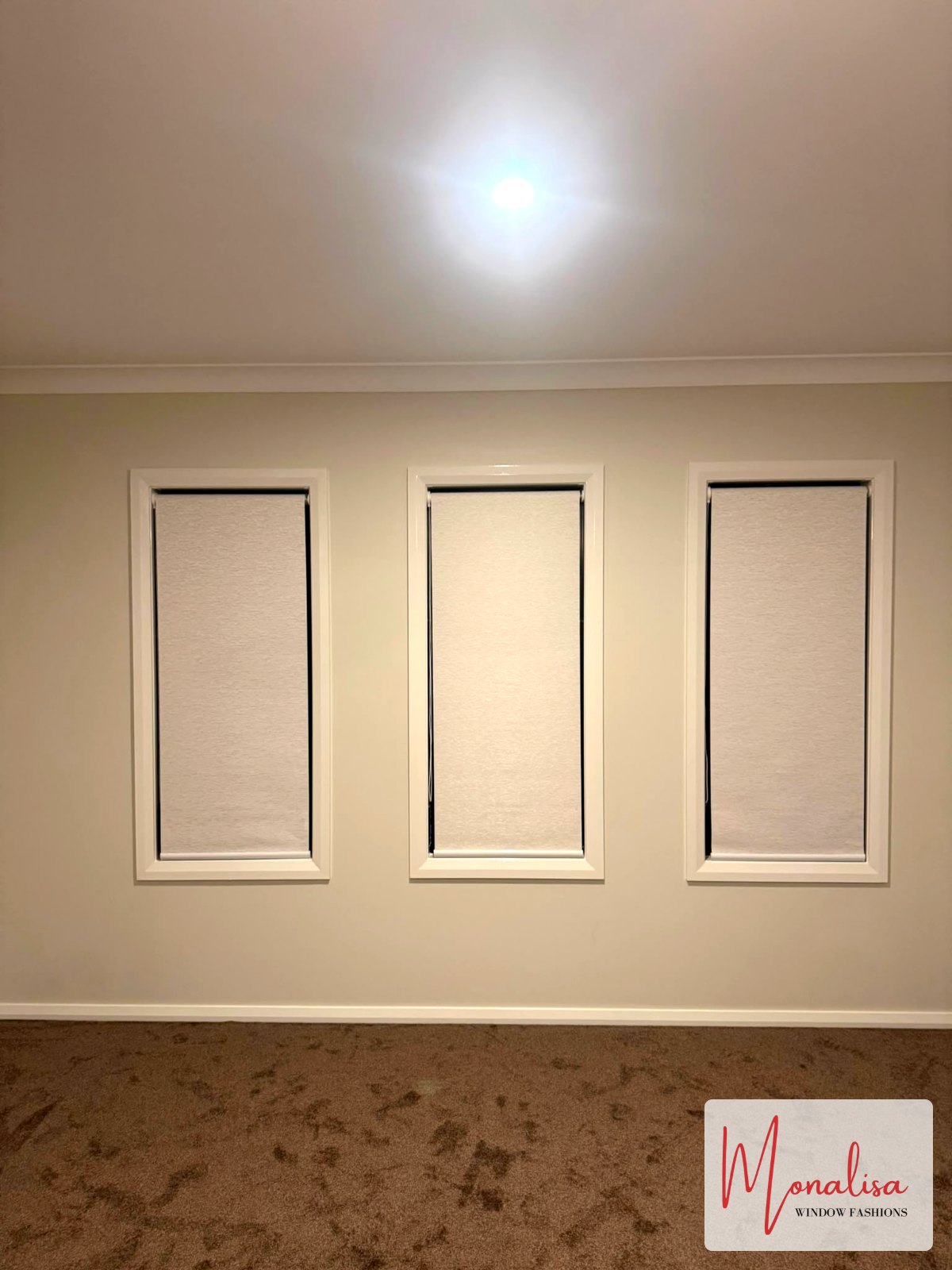 Three blockout roller blinds fitted to bedroom windows in a new Gables home