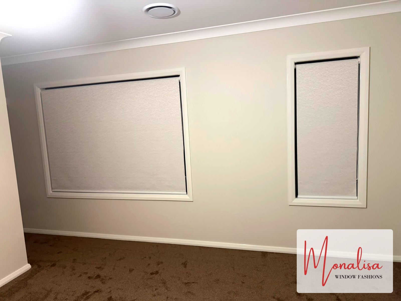 Blockout roller blinds on a wide window and side window in a Gables master bedroom