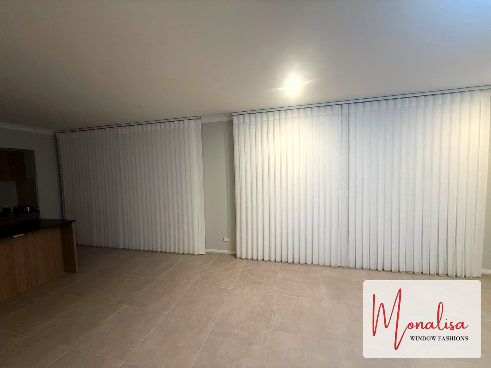 White S-Fold sheer curtains across two large windows in a Gables new home
